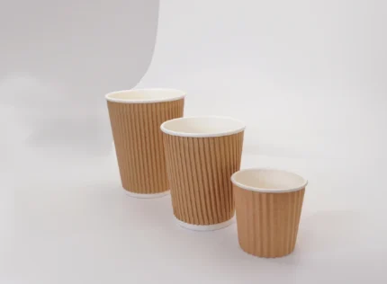 "Assorted sizes of ribbed brown coffee cups on a pristine white background, highlighting versatile packaging options from www.jcpackagingdubai.com."