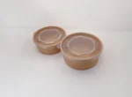 "Two brown paper food containers with secure lids on a white surface, reflecting the quality packaging from www.jcpackagingdubai.com."