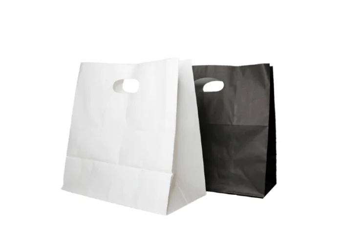 "Two paper bags, one white and one black, with die-cut handle holes, against a white background."