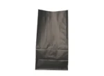 "A black paper bag is laid out flat on a plain background, with creases visible from previous use or storage."