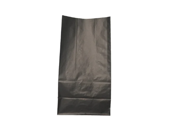 "A black paper bag is laid out flat on a plain background, with creases visible from previous use or storage."