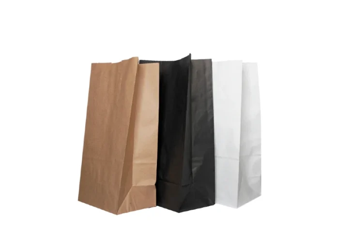 "Three paper bags in brown, black, and white stand side by side, representing a range of classic color choices for packaging."