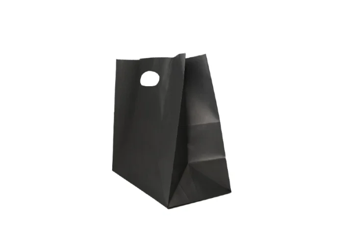 "A single black paper bag with a round die-cut handle hole, standing against a light background."