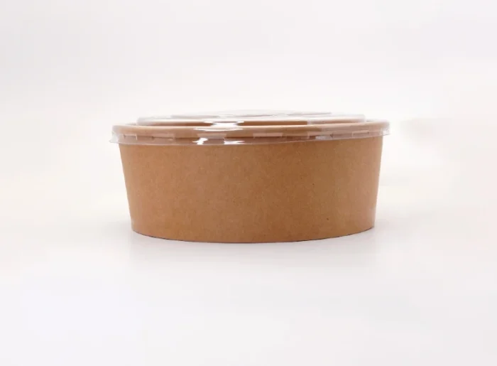 "A brown paper food container with a transparent lid on a white background, highlighting JC Packaging Dubai's simple yet sustainable packaging at www.jcpackagingdubai.com."