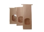 "Three brown paper bags with transparent windows, staggered for display."