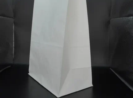 "An upright white paper bag with a sophisticated silhouette, a testament to JC Packaging Dubai's refined packaging solutions at www.jcpackagingdubai.com."