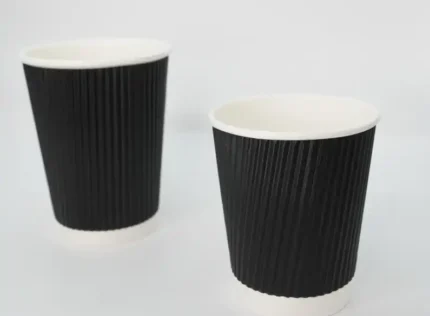 "Two premium black ripple paper cups designed for optimal insulation, offered by JC Packaging Dubai, showcasing sophisticated packaging solutions."