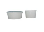 "Two white ice cream bowls with lids on a dark surface, ideal for serving frozen treats from www.jcpackagingdubai.com."